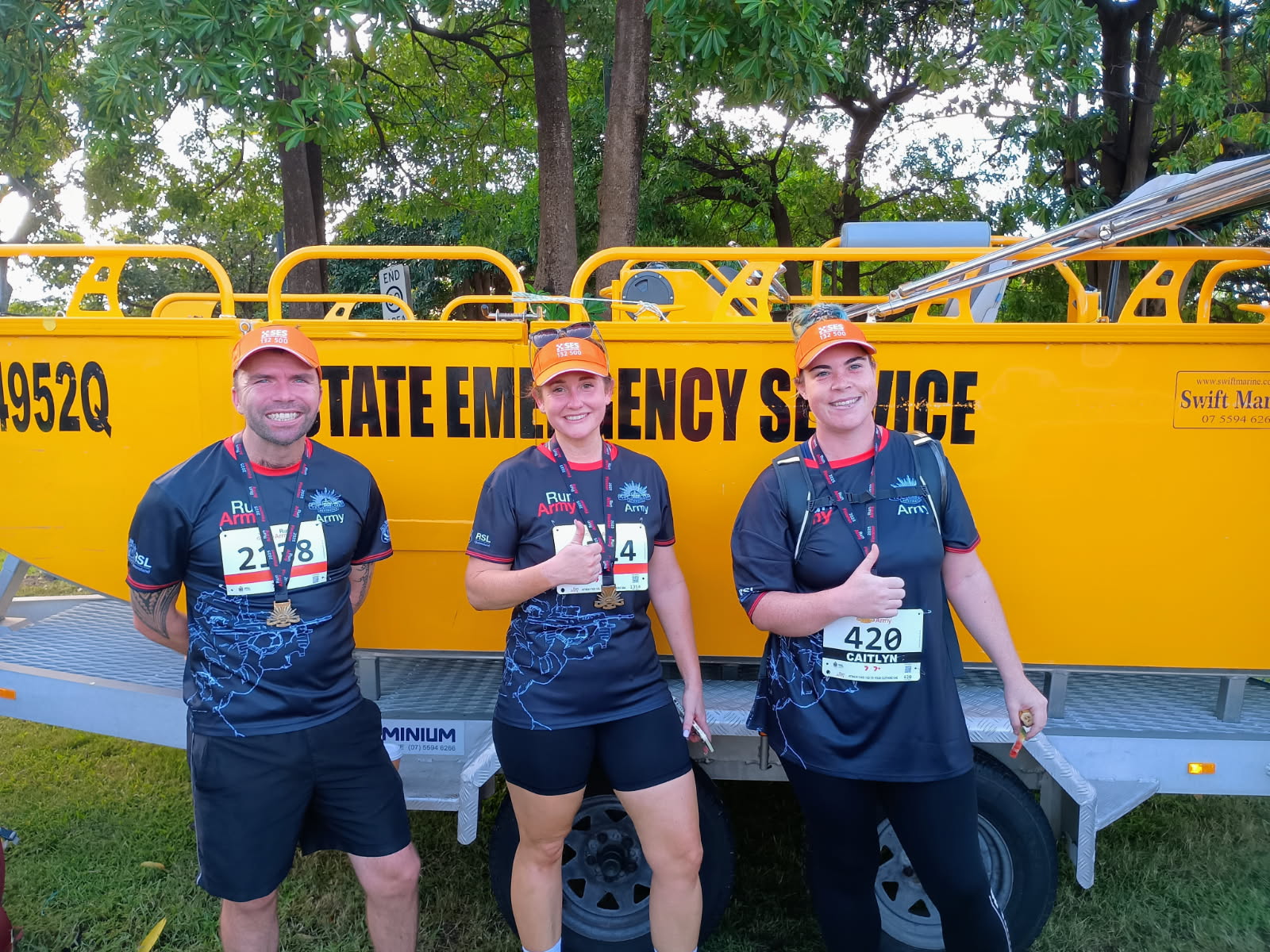 Run Army runners standing in front of SES flood boat