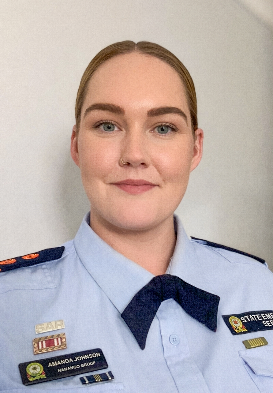 Portrait of female SES member in uniform on plain background.