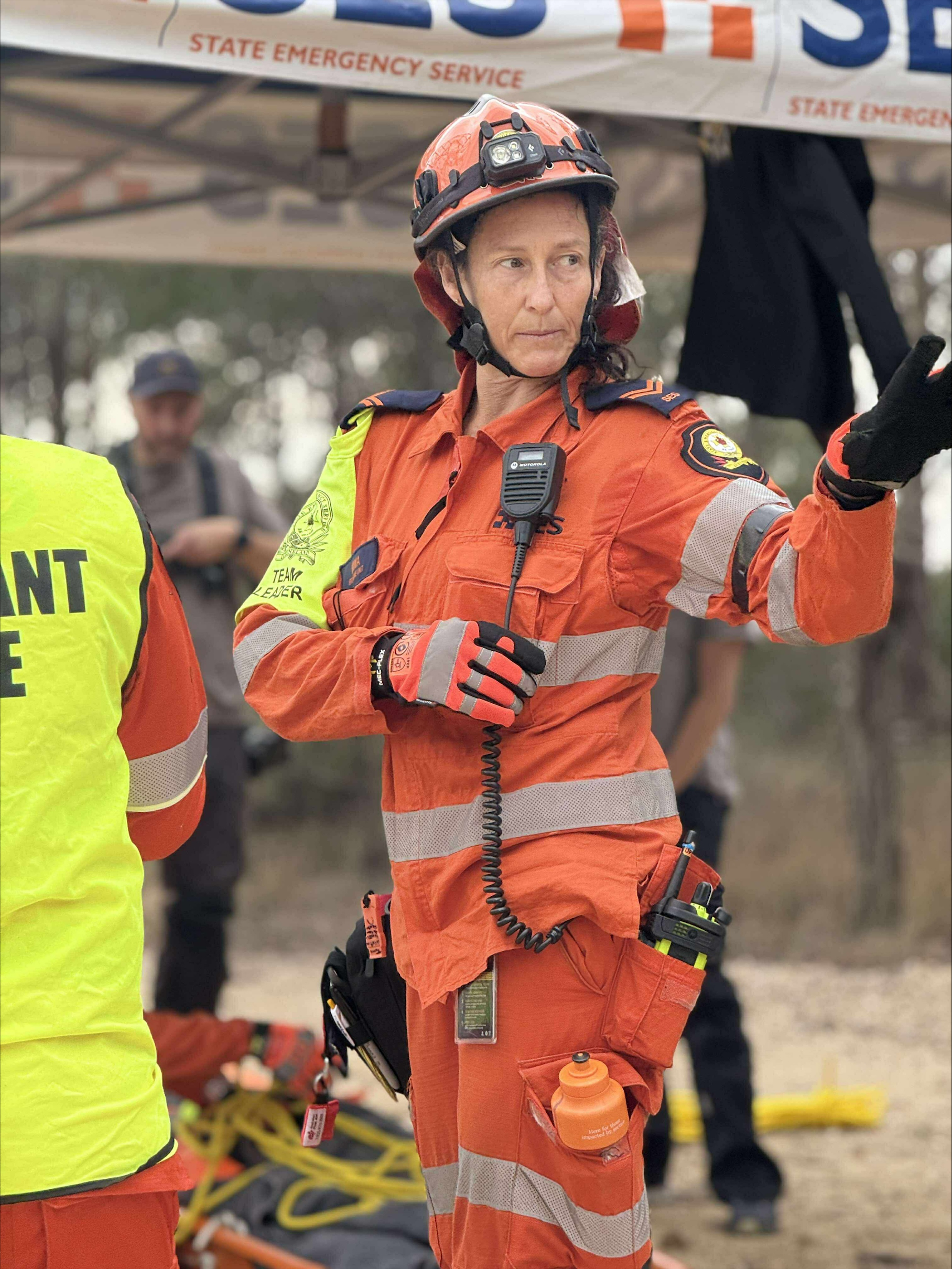 SES Volunteer in full PPE standing appearing to be giving directions for an activity.