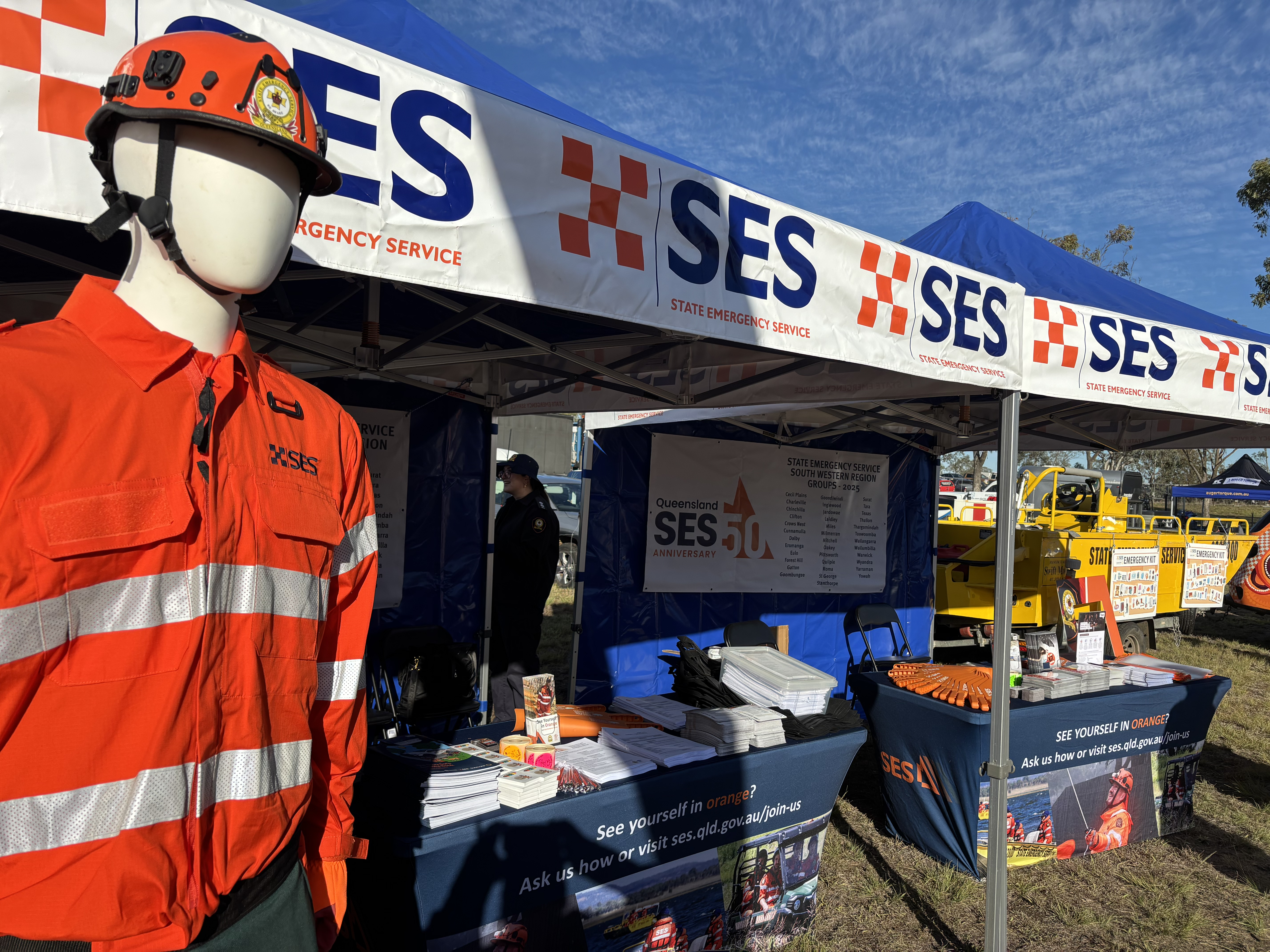 SES event stall, outdoors. The stall contains various engagement activities and demonstrations of uniforms.